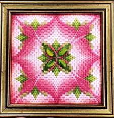 pink and green flower-like embroidery piece